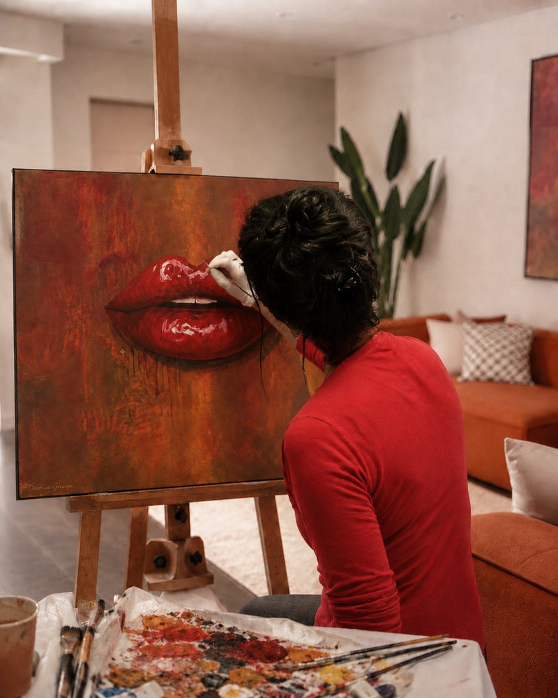 Dounia G. painting the original Moka Bliss lips artwork on canvas in her Dubai atelier
