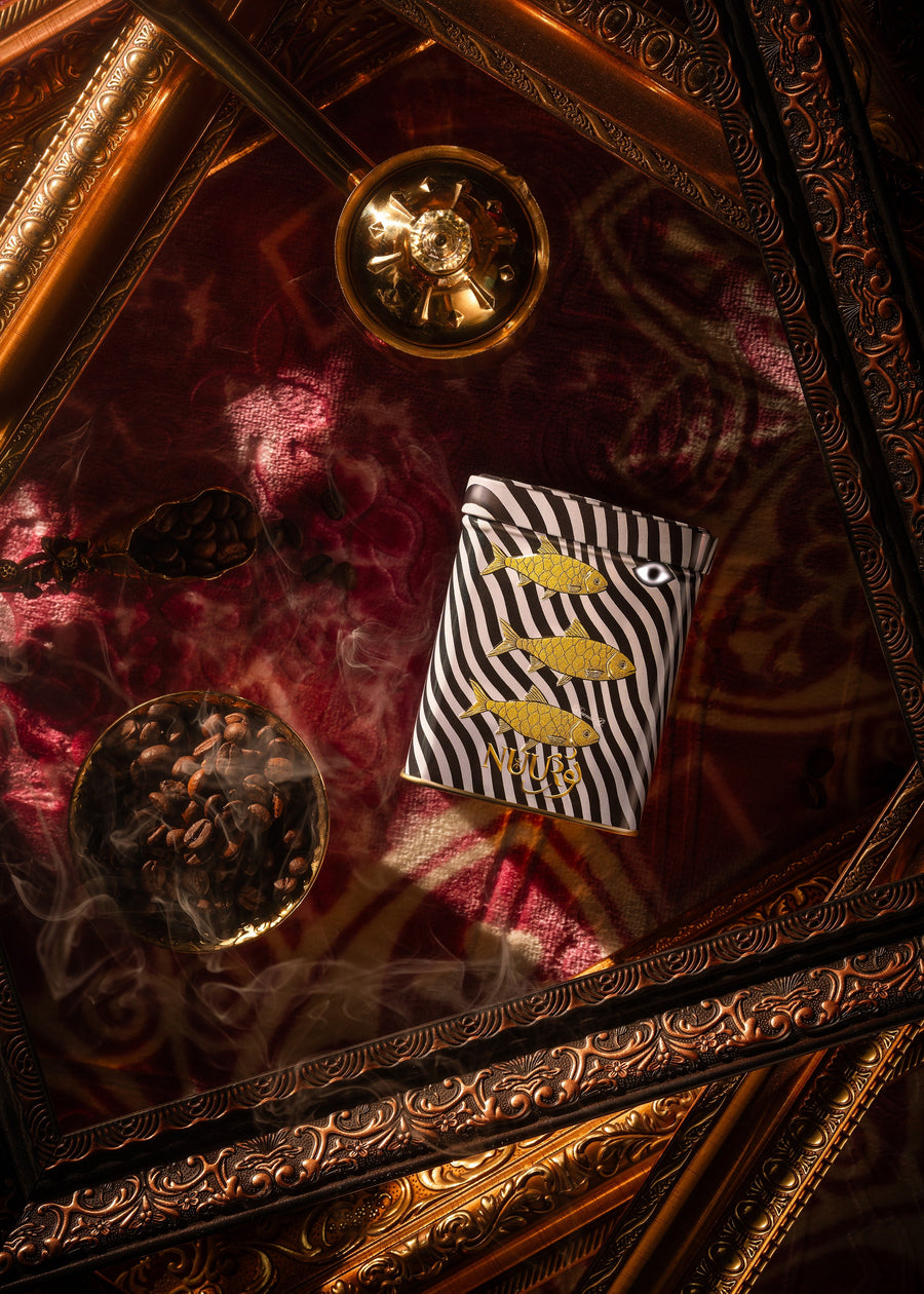 Manaima artwork tin on brass tray with coffee beans and incense