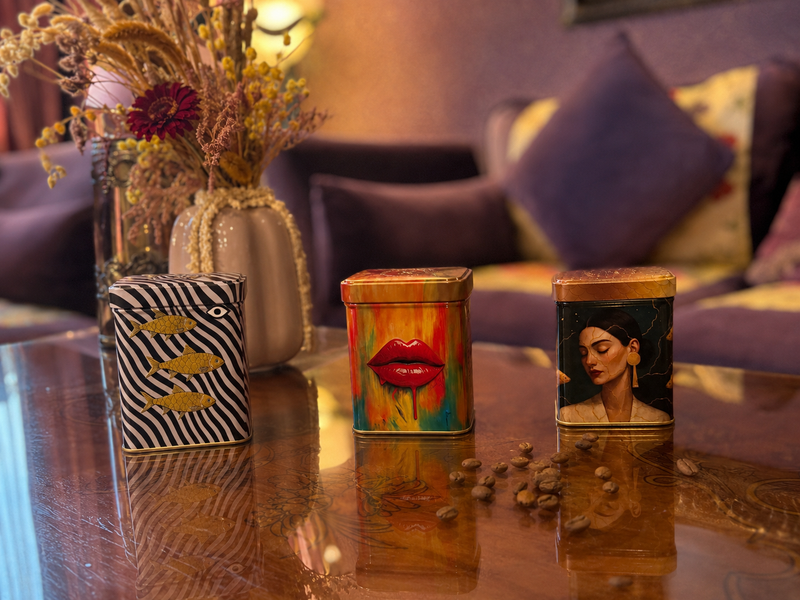 Moka Bliss, Manaima white-eye and Golden Aura artwork tins in a violet salon