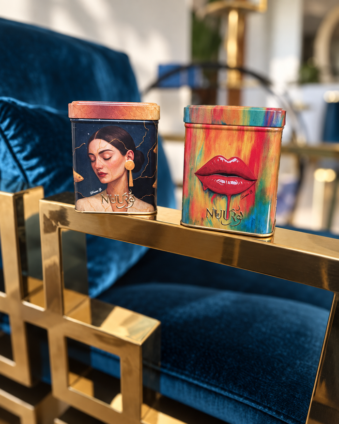 Three NUUR art tins on blue velvet in a home